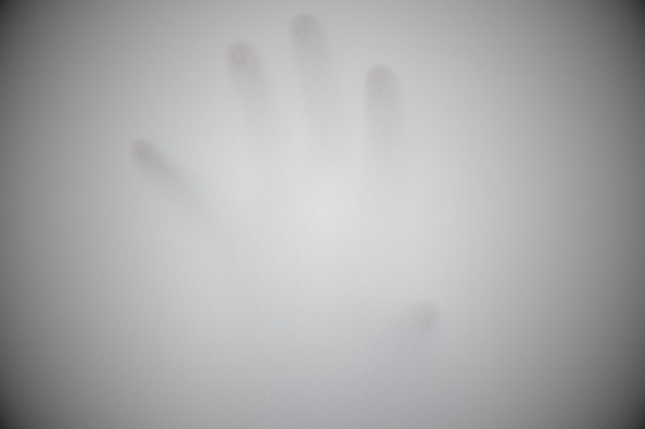 a hand pushing through fog